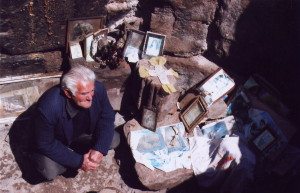 Razmig Manoogian sits among the rubble at Ptghni Church, which has remained his personal sanctuary over the past 50 years.