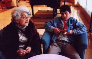 Larissa discusses her role as a foster mom to 16 children in Yerevan while a son looks on. (Tom Vartabedian photo)