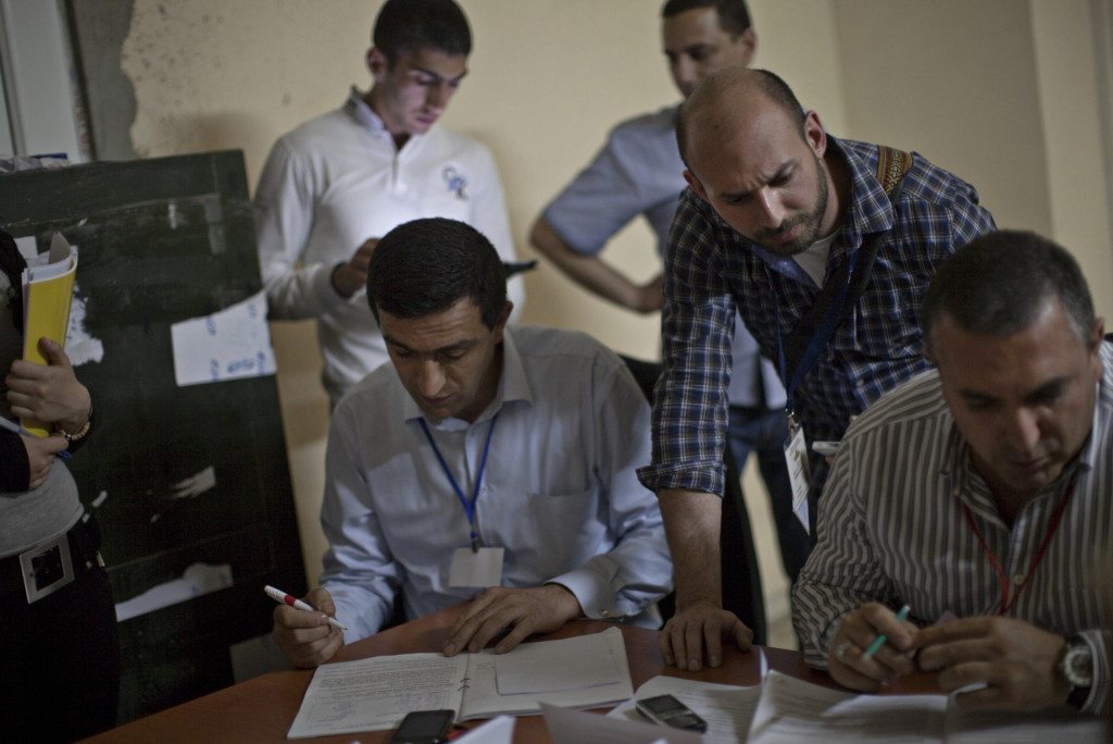 Diasporan repatriate Babken Der Grigorian watches the vote counting process after the polls close.