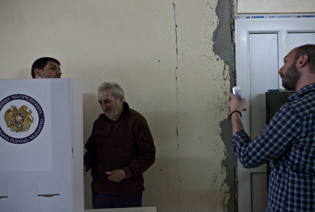 Diasporan repatriate Babken Der Grigorian documents two people approaching the voting booth together. (Photo by Eric Grigorian)