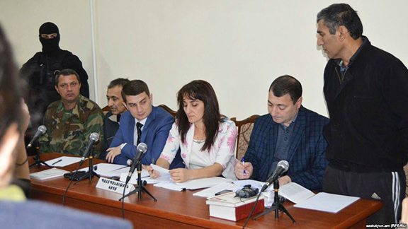 Guliyev (right) and Askerov (third from left) stand trial in Stepanakert on Oct. 27 (RFE/RL photo)