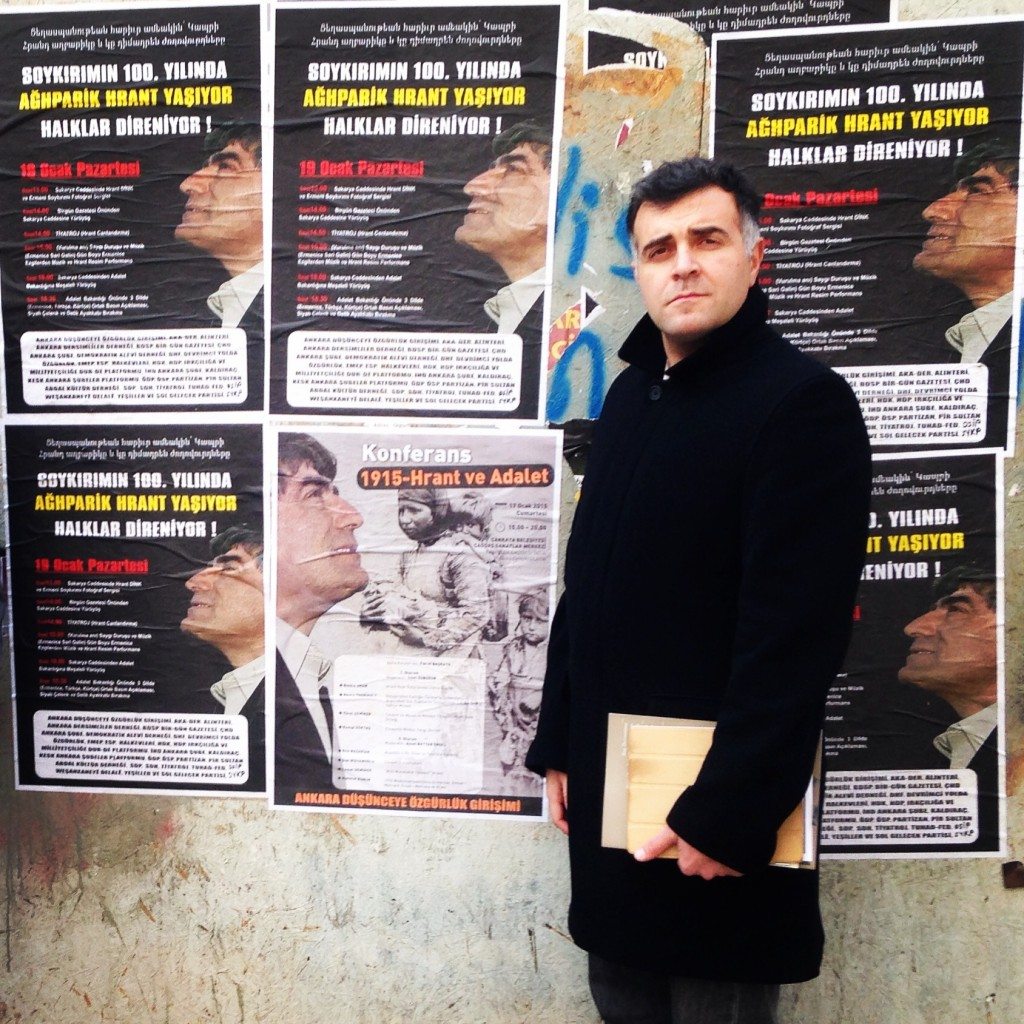 Eric Nazarian stands in front of posters for the conference, ‘1915, Hrant and Justice,’ in Ankara.