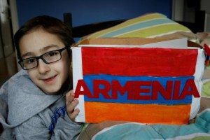 Rocco Vartabedian, 8, with his four-sided Armenian Genocide project that he presented to his school
