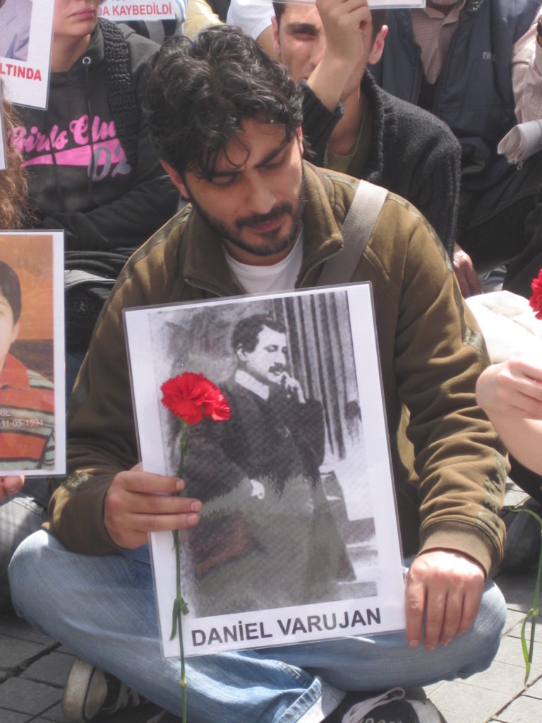 An activist holding poet Daniel Varoujan’s photo at one of the commemoration events in Istanbul. (Photo: Khatchig Mouradian)