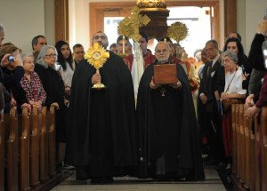 Fr. Garabed Kochakian and Fr. Hrant Kevorkian lead the procession into St. Mary’s carrying relics of the saints, which were placed at a special altar table. (Photo: Vaughn Gurganian) 