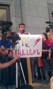 Maxim Sargsyan, a member of the 'No to Plunder' civic initiative, at the podium (Photo: Serouj Aprahamian)