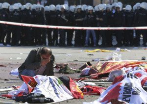 A man cries over the body of a victim, at the site of an explosion in Ankara, Turkey, on Oct. 10. (AP Photo/Burhan Ozbilici)