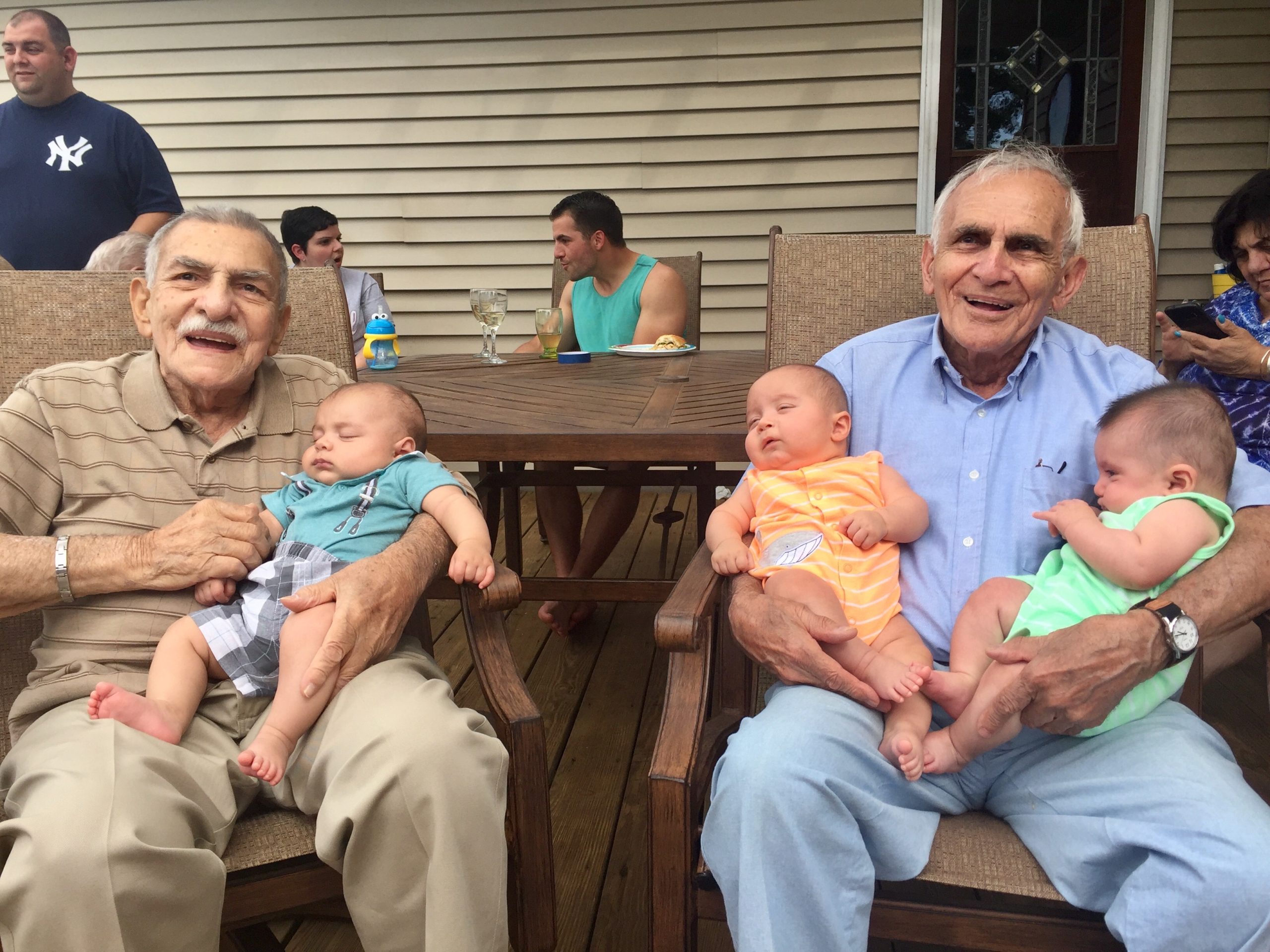 Grampie with his late brother Marty Sarkisian. The pair hold their great-grandsons Lucas, Alessio, and Alexan (left to right)