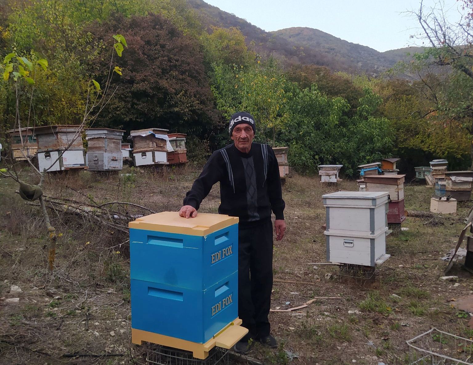 Experience beekeeper Alexander Ghazyan tending to his beehives