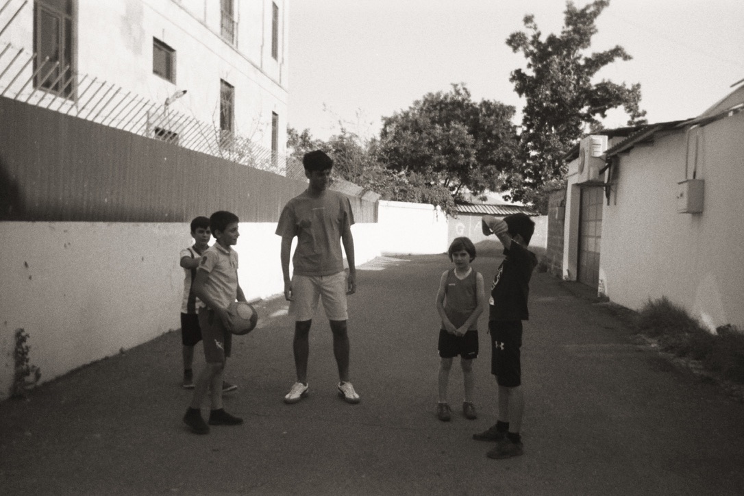 AYF intern Artush Sarkisian playing soccer with neighborhood children