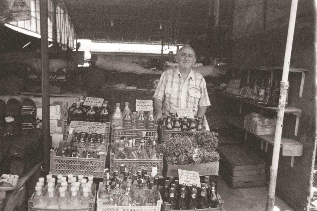 Artsakhsi elder selling his homemade vodka and remedies