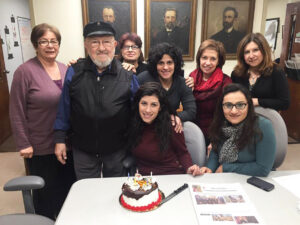 A group photo with a birthday cake