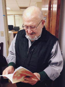 Tatul Sonentz-Papazian leafs through a book